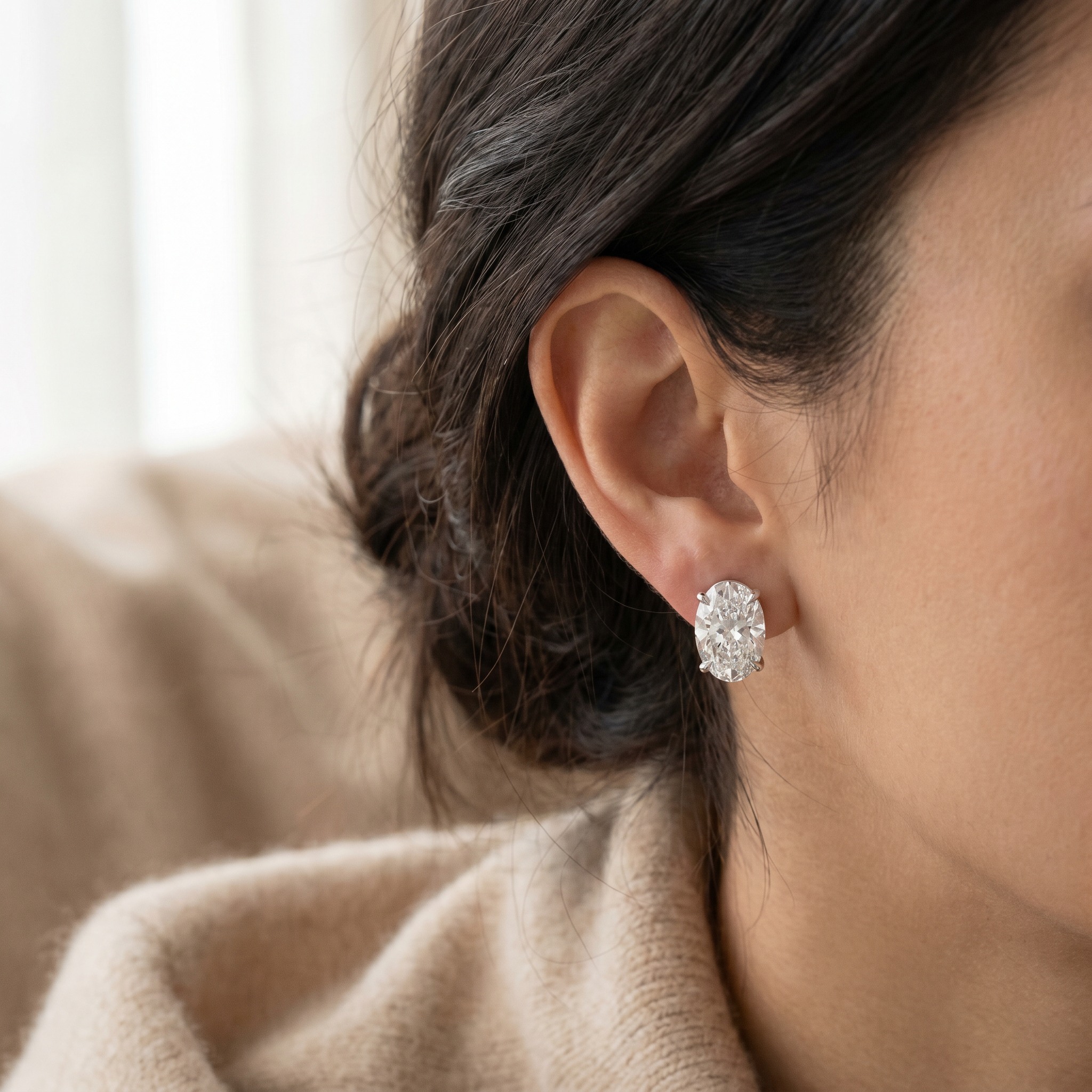 Oval Cut Diamond Stud Earrings — on ear lifestyle
