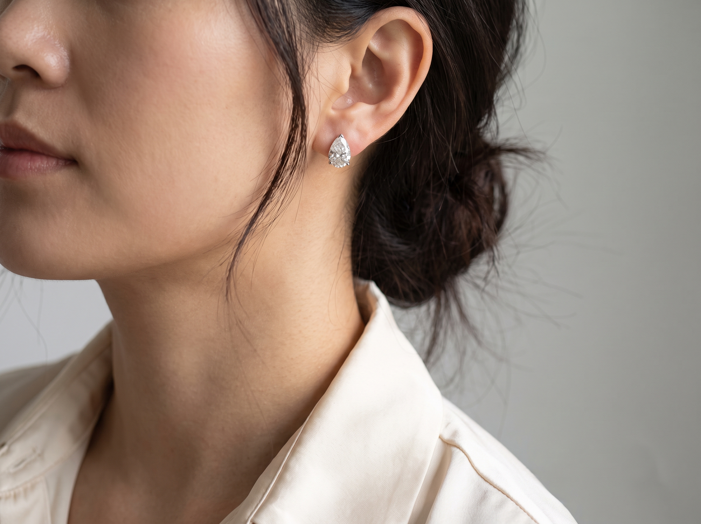 Pear Cut Diamond Stud Earrings — on ear lifestyle